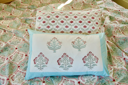 Decorative pillows with floral patterns on a matching fabric background