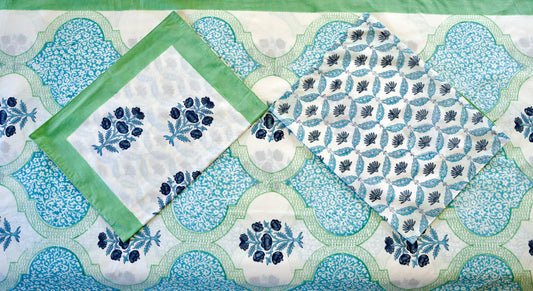 zure Lattice hand block printed organic cotton bedsheet with navy floral clusters, teal-green leaves, white base, aqua lattice panels, and matching floral patterned pillowcases
