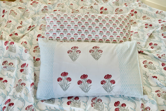 Floral patterned pillow and bedspread on a bed