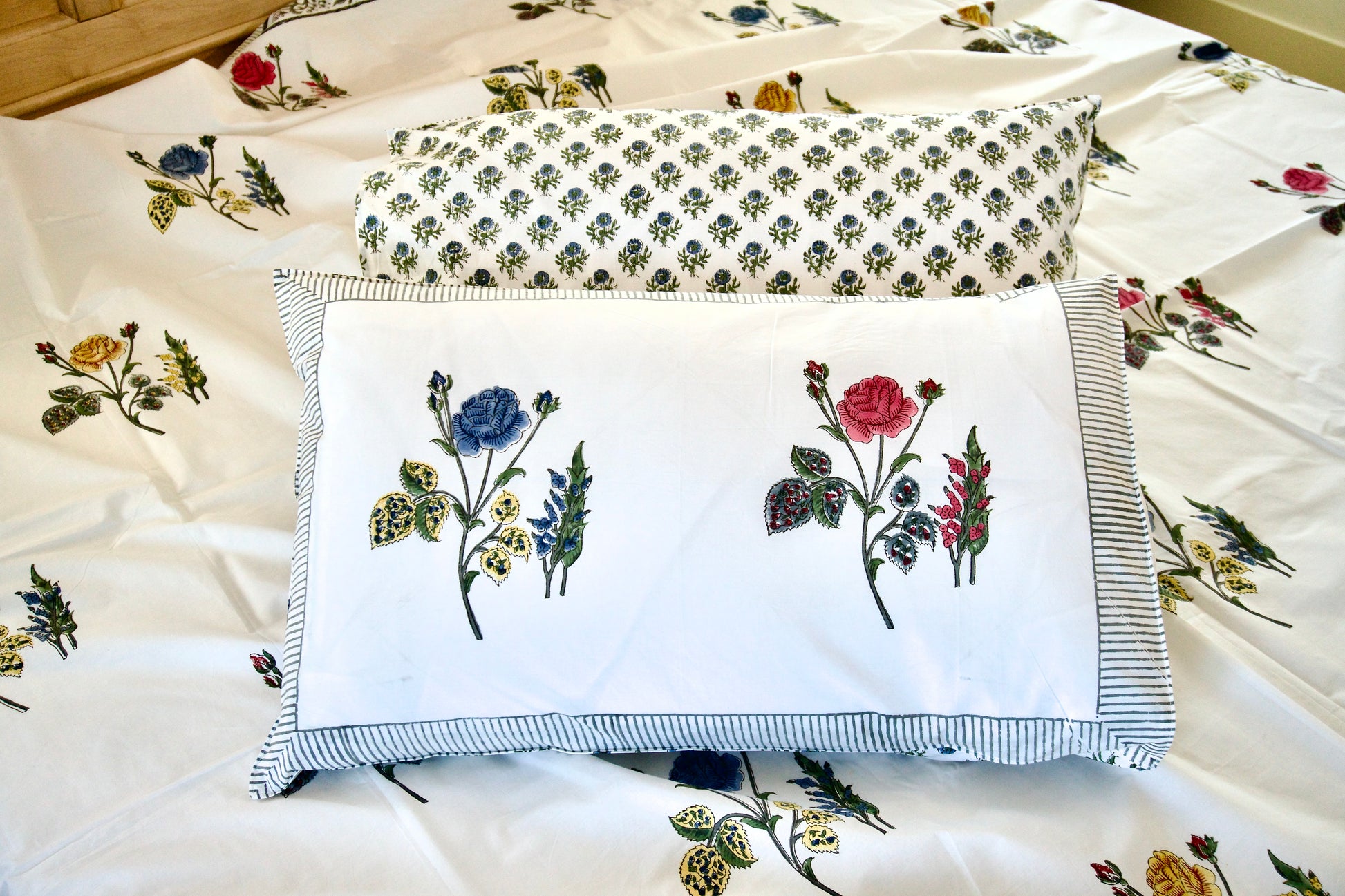 Floral embroidered pillows on a floral fabric background