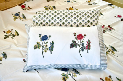 Floral embroidered pillows on a floral fabric background