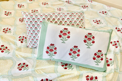 Scarlet Boughs hand block printed organic cotton bedsheet with red floral clusters, green leaves, white base, sage border pillow, and floral repeat pillowcases with yellow panel background