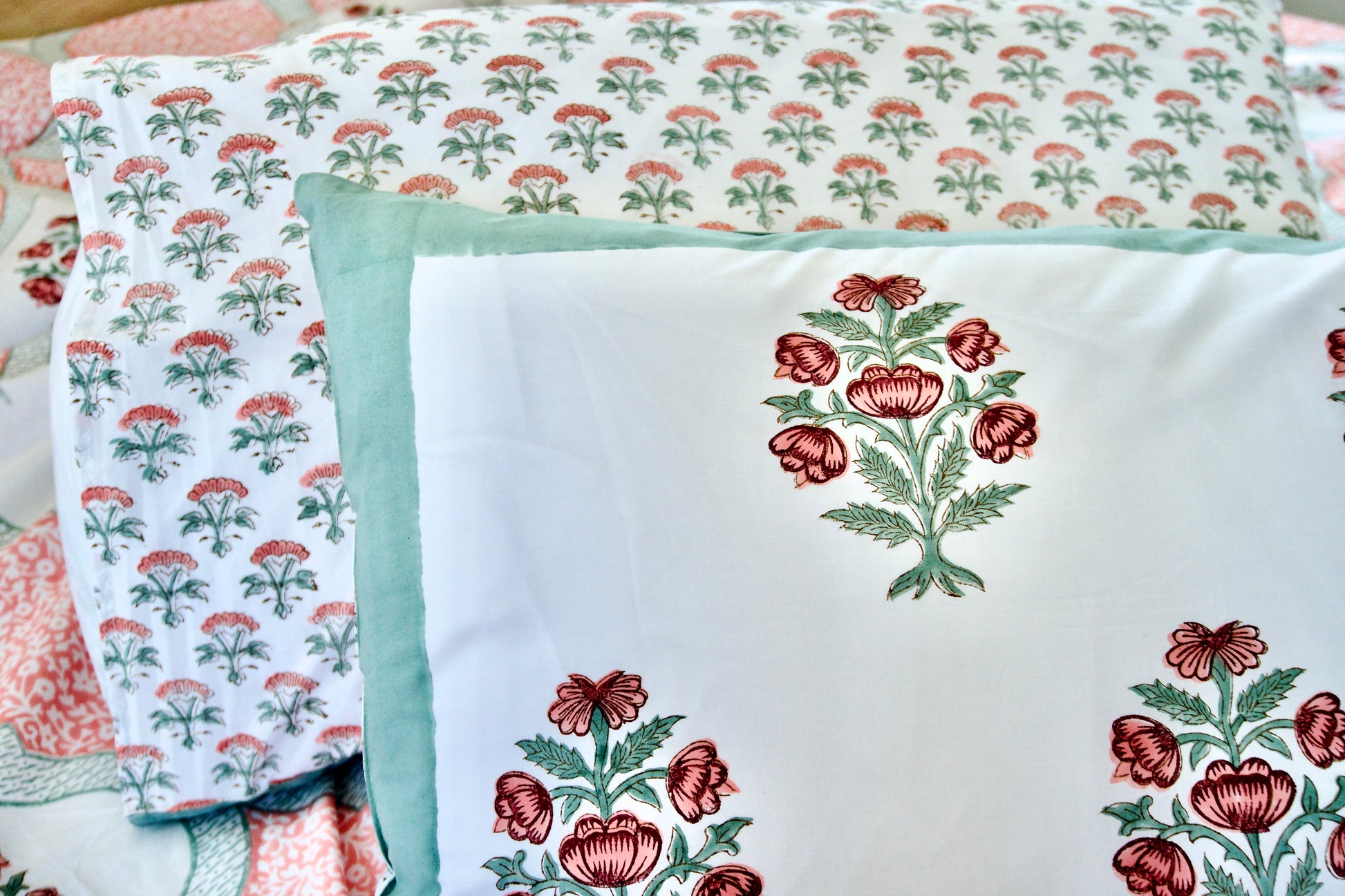 Floral patterned fabric with embroidered designs on a quilt