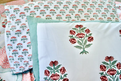 Floral patterned fabric with embroidered designs on a quilt