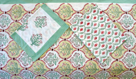 Verdant Arch hand block printed organic cotton bedsheet with green leafy motifs framed in golden arches with red accents on a white base, paired with green-bordered and vine-patterned pillowcases